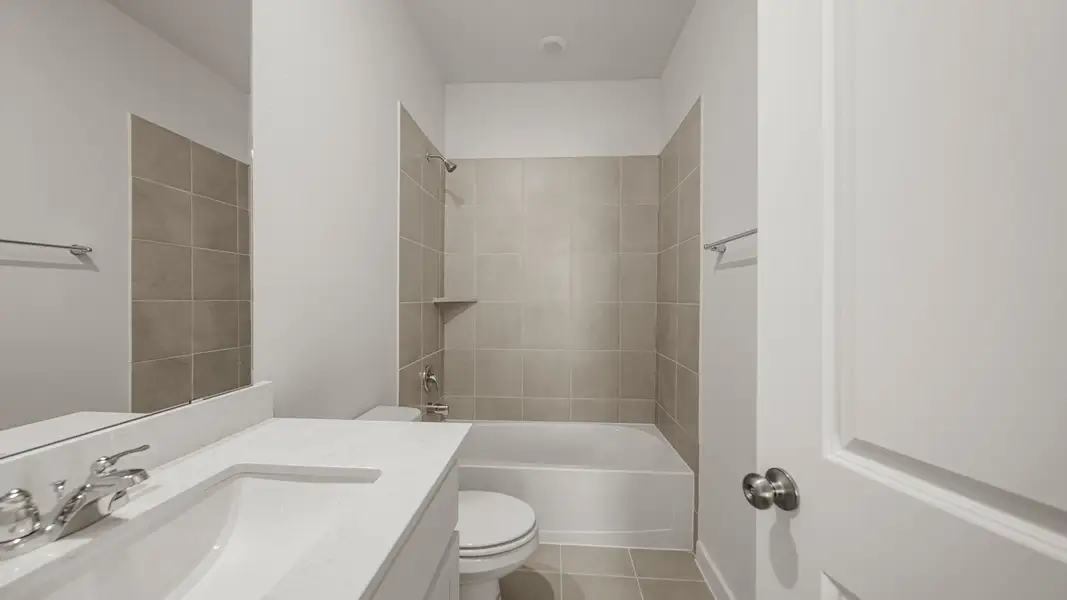 A bathroom with a tub sink and toilet.