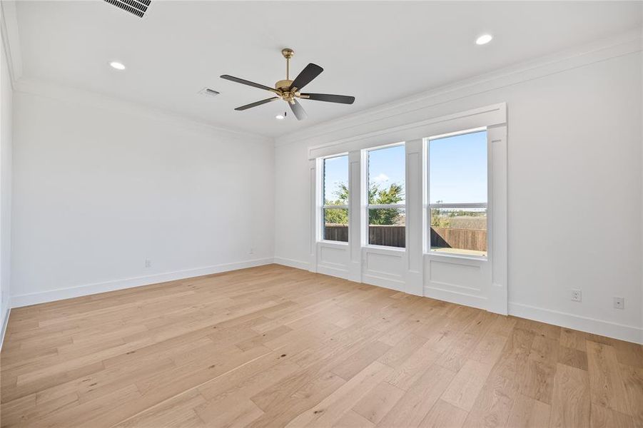 Empty room with ornamental molding, light wood-style flooring, recessed lighting, and ceiling fan Empty room with ornamental molding, light wood-style flooring, recessed lighting, and ceiling fan
