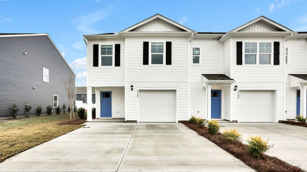 Front exterior of a new home in The Landing at Sidbury Station, Castle Hayne, NC, highlighting curb appeal (Image 1). Front exterior of a new home in The Landing at Sidbury Station, Castle Hayne, NC, highlighting curb appeal (Image 1).