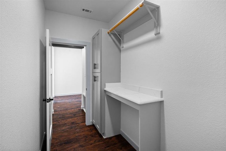 Large laundry room with plenty of storage and counter tops