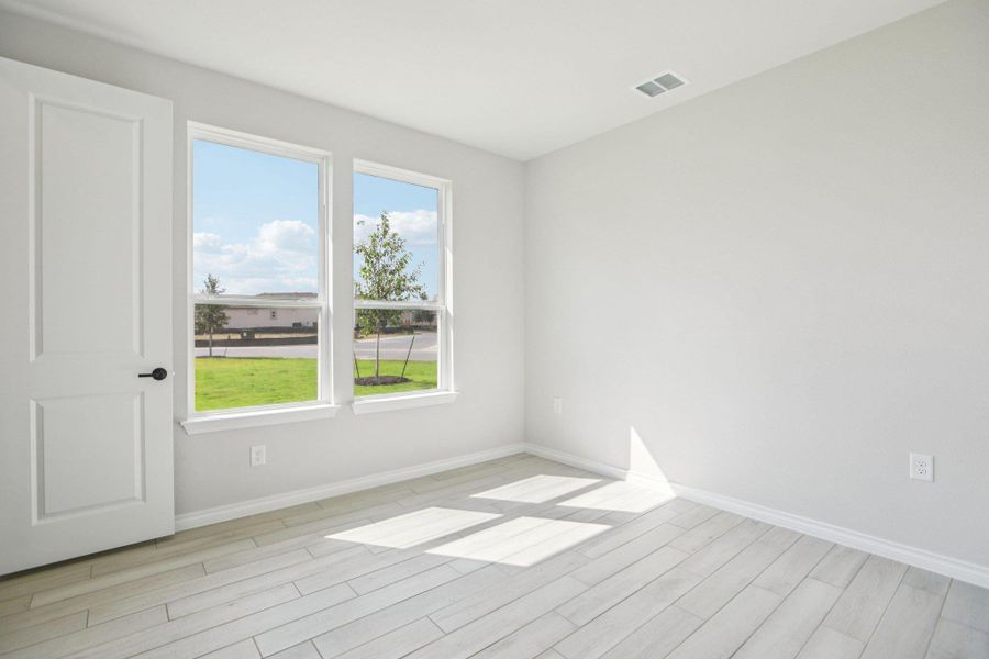 Unfurnished room with baseboards and light wood-style floors