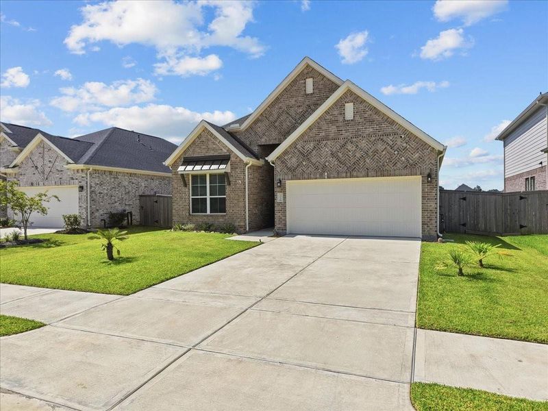 Welcome home to a beautifully maintained exterior showcasing a spacious driveway, easy-care landscaping, and stunning palm accents that create a relaxed, inviting atmosphere from the moment you arrive. Welcome home to a beautifully maintained exterior showcasing a spacious driveway, easy-care landscaping, and stunning palm accents that create a relaxed, inviting atmosphere from the moment you arrive.