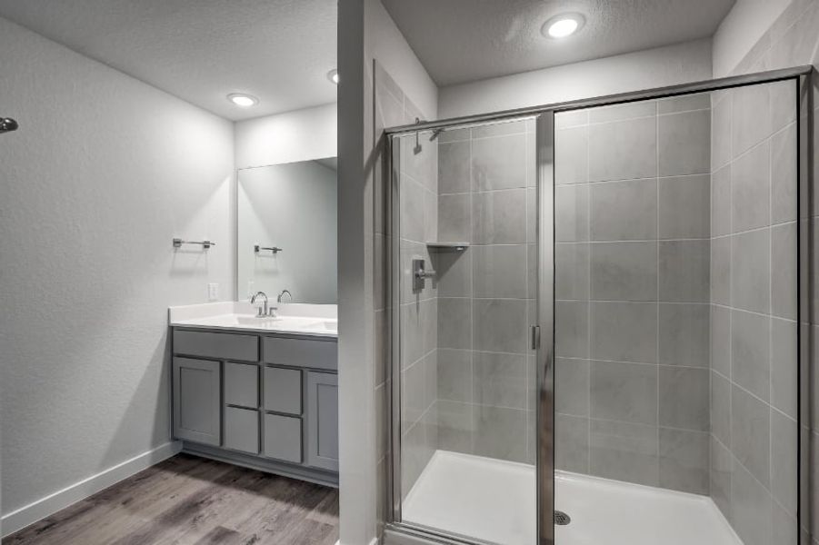 A bathroom with a glass shower. A bathroom with a glass shower.