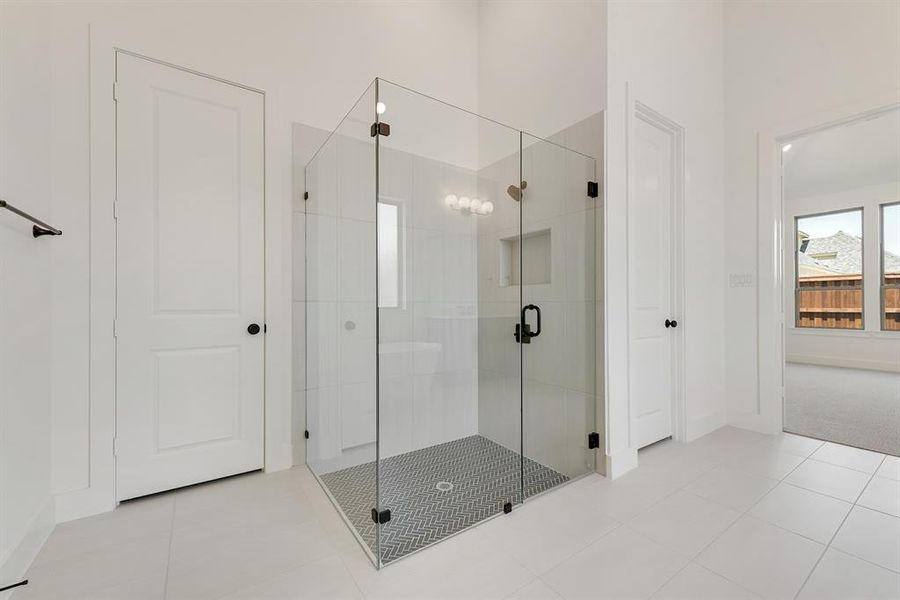 Full bath with tile patterned flooring and a stall shower Full bath with tile patterned flooring and a stall shower