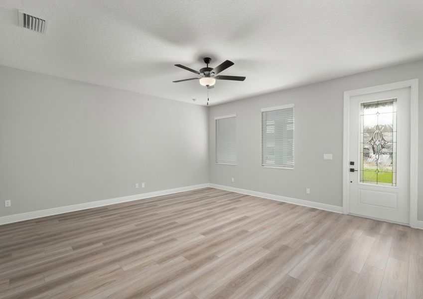 Family room with the 3/4 lite door and two windows with blinds