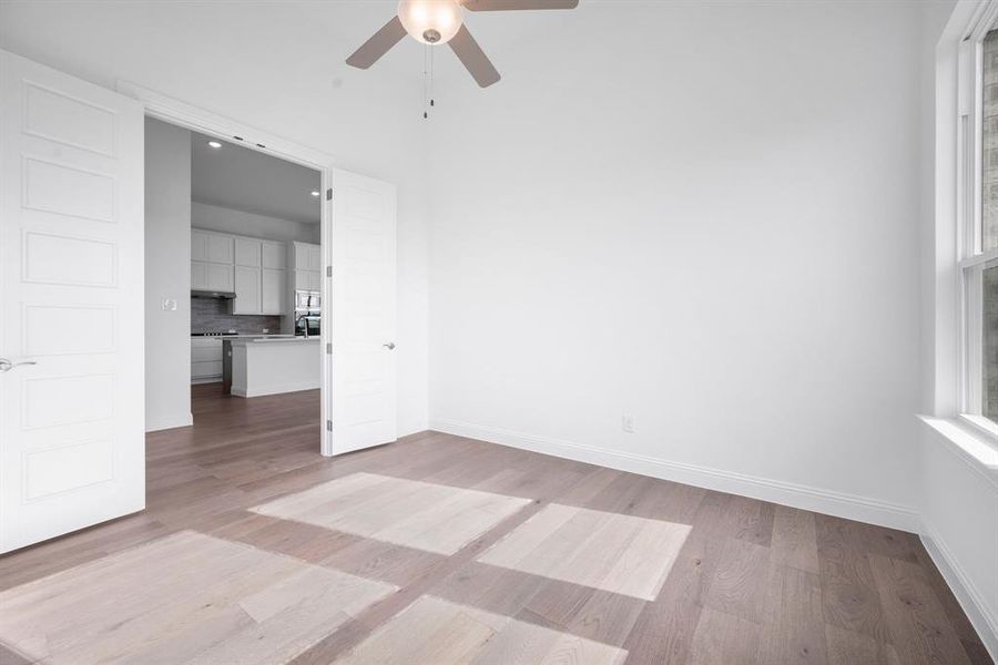 Office or flex space featuring ceiling fan, a healthy amount of sunlight, and light hardwood / wood-style flooring