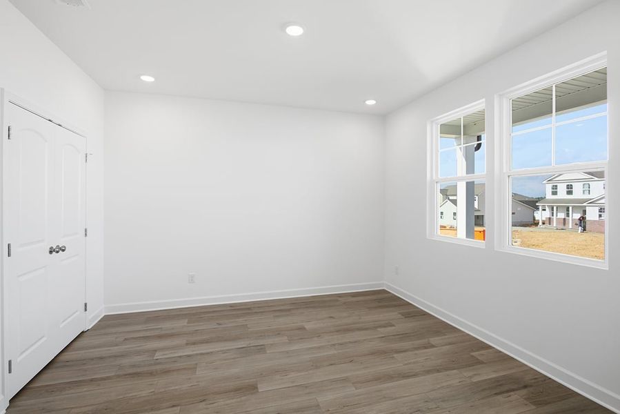 A room with white walls and a wood floor. A room with white walls and a wood floor.