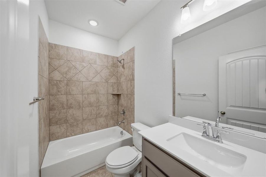 Full bathroom with washtub / shower combination and vanity
