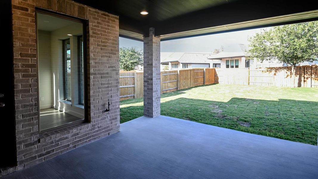 Fenced backyard featuring a patio area Fenced backyard featuring a patio area