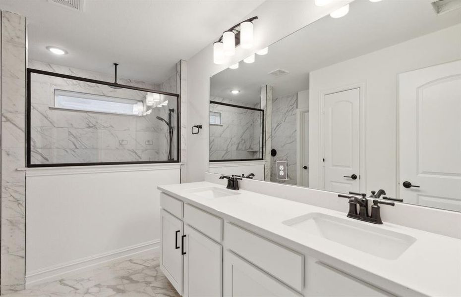 Spacious owner's bathroom with oversized shower and dual vanity *real home pictured