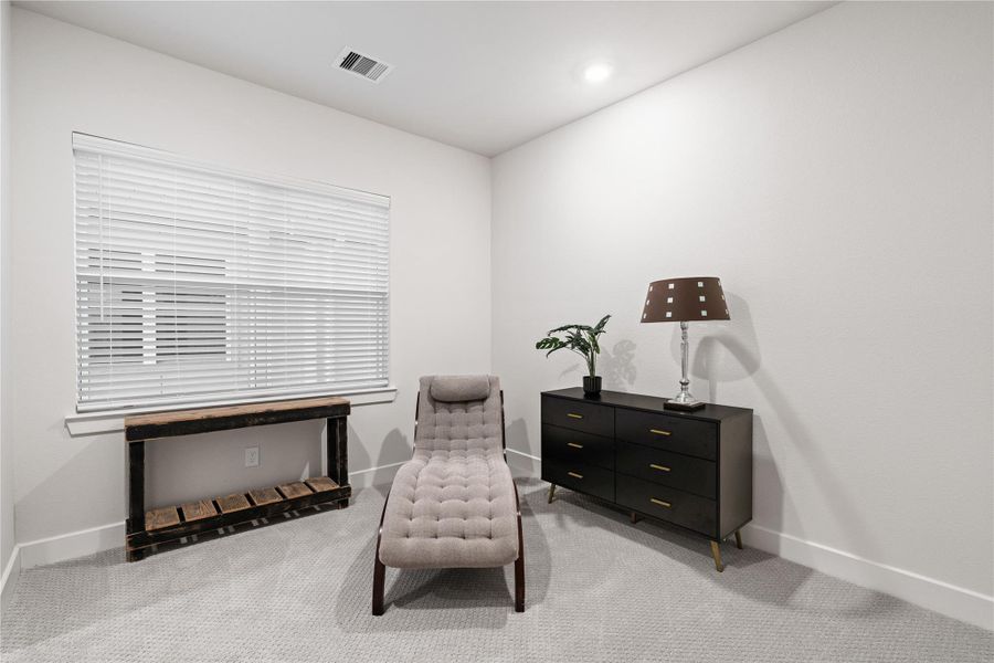 Secondary bedroom with soft carpet and natural light, sized comfortably for everyday use.