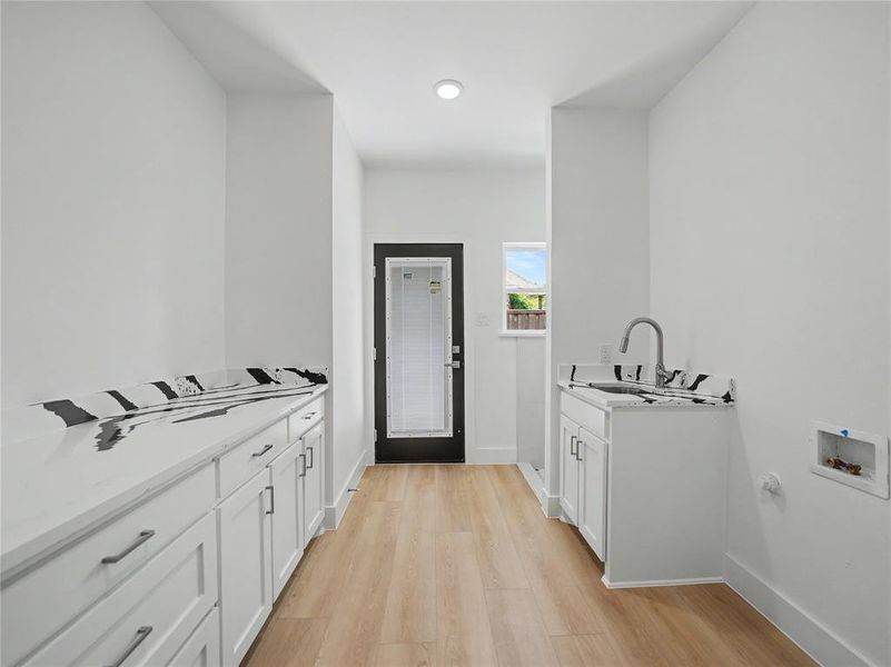 Utility space with light wood-finish flooring Utility space with light wood-finish flooring