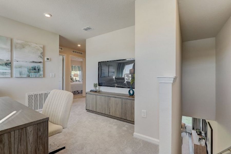 A living room with a tv and a couch. A living room with a tv and a couch.