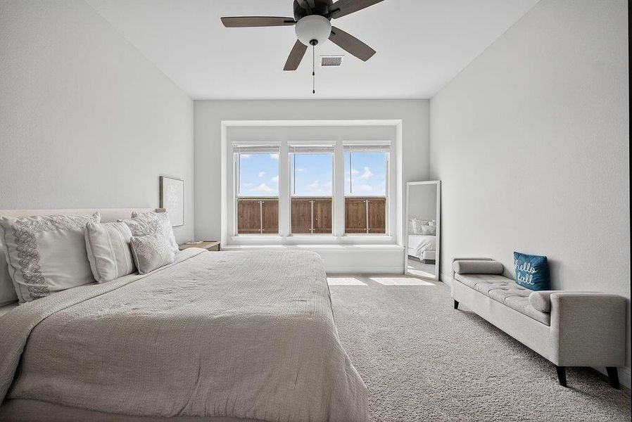 Spacious room featuring light-toned walls and plush carpeting