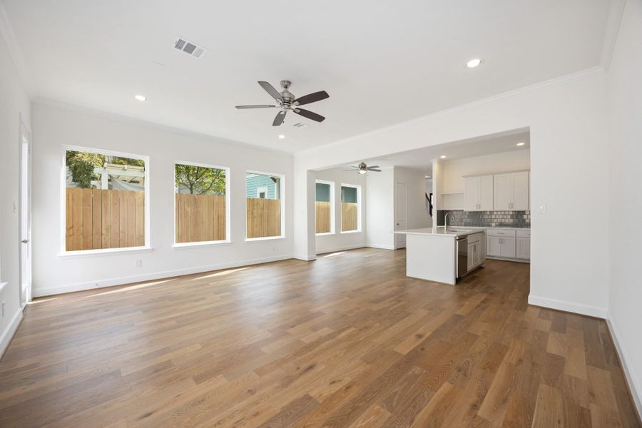 This wide-angle view shows off the magic of first-floor living—kitchen, dining, and living all connected in one beautifully cohesive space.