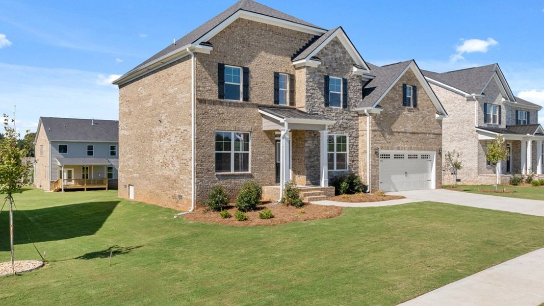 Front exterior of a new home in Heritage Pointe, Senoia, GA, highlighting curb appeal (Image 26). Front exterior of a new home in Heritage Pointe, Senoia, GA, highlighting curb appeal (Image 26).