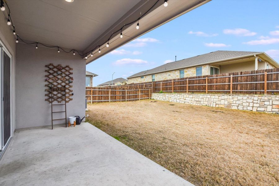 View of yard featuring a fenced backyard and a patio