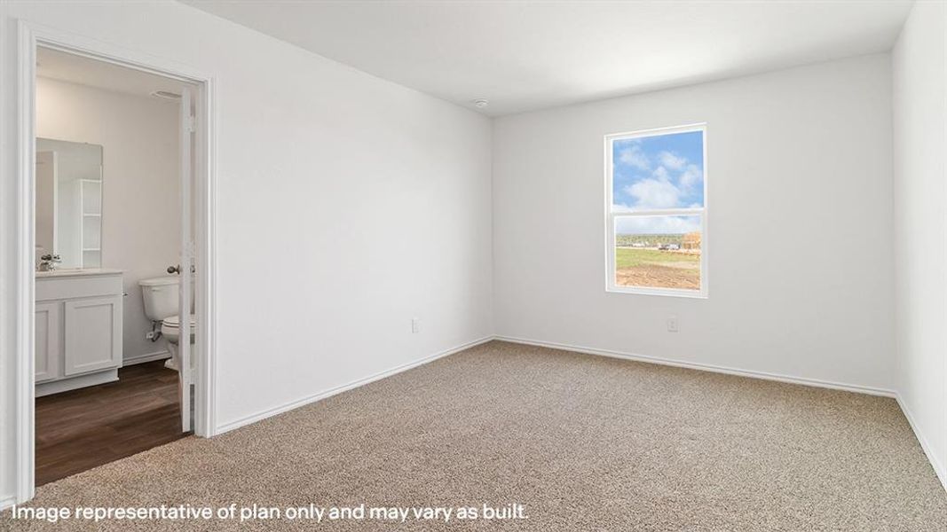 Carpeted spare room with baseboards