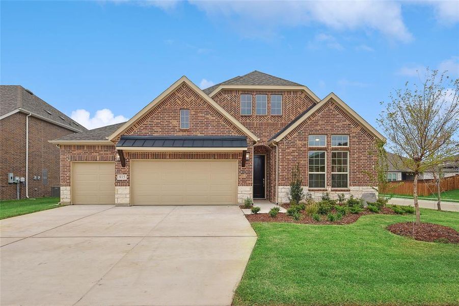 View of front facade featuring a front yard and a garage