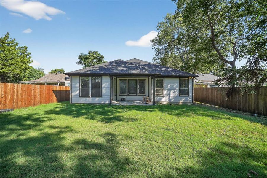 Back of property featuring a patio and a fenced backyard