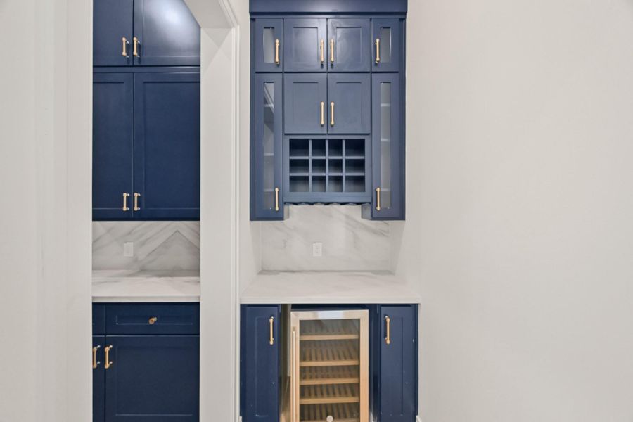 The bar and beverage center is tucked conveniently by the dining room!