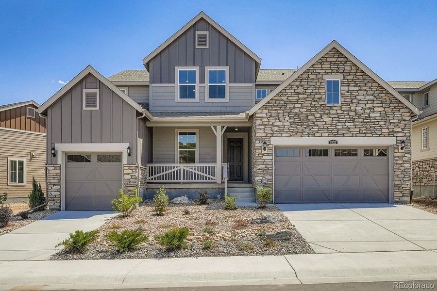 Front exterior of a new home in Macanta: The Grand Collection, Castle Rock, CO, highlighting curb appeal (Image 1).