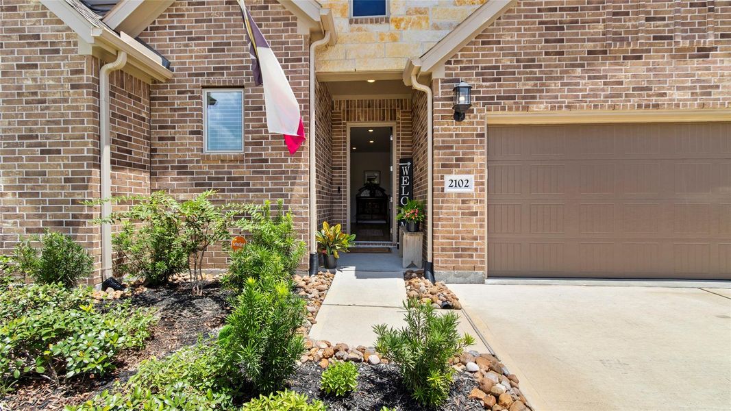 This entrance offers sophistication as represented by the front door, covered entrance and beautifully landscaped front yard This entrance offers sophistication as represented by the front door, covered entrance and beautifully landscaped front yard