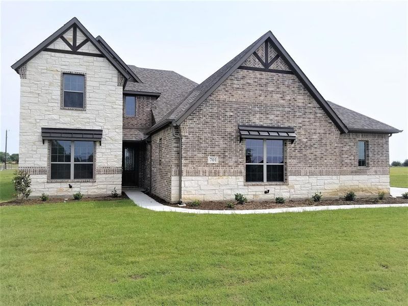 Front exterior of a new home in Pecan Grove, Whitesboro, TX, highlighting curb appeal (Image 1). Front exterior of a new home in Pecan Grove, Whitesboro, TX, highlighting curb appeal (Image 1).