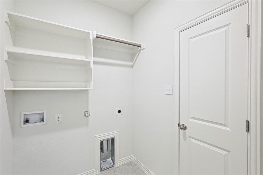 Laundry room with hookup for a gas dryer, washer hookup, light tile floors, and electric dryer hookup