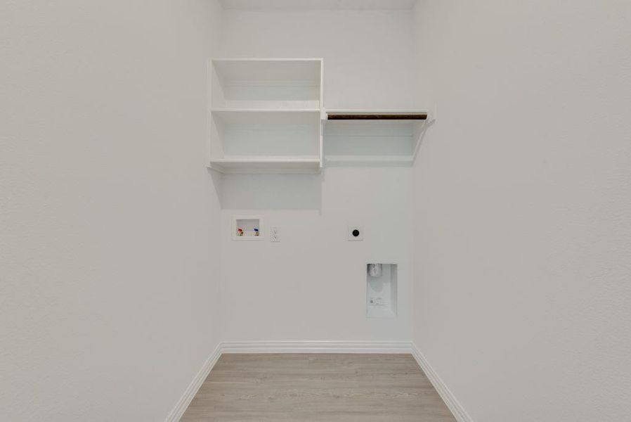 Laundry room with electric dryer hookup, washer hookup, and light wood finished floors Laundry room with electric dryer hookup, washer hookup, and light wood finished floors