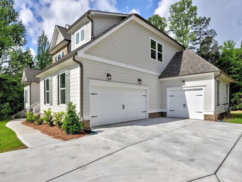 Front exterior of a new home in , Cumming, GA, highlighting curb appeal (Image 32). Front exterior of a new home in , Cumming, GA, highlighting curb appeal (Image 32).