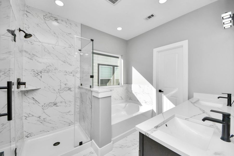 Dual vanity with garden tub and stand up shower.