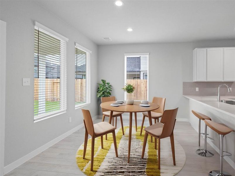 Start your day off right with a cup of coffee sitting with your family in the lovely dining/breakfast area! Featuring large windows with blinds, custom neutral paint, tile flooring, recessed lighting and high ceilings!