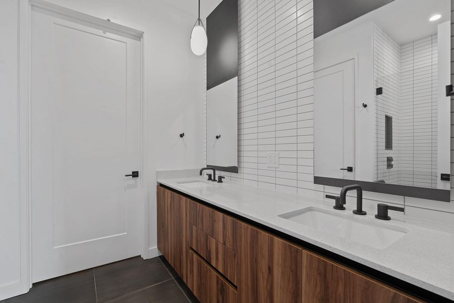 The Midcentury Austin design elements are evident in the tasteful tile selections and wood accents.