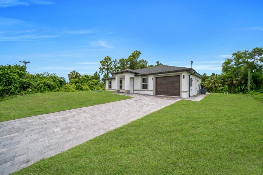 Front exterior of a new home in , Lehigh Acres, FL, highlighting curb appeal (Image 17). Front exterior of a new home in , Lehigh Acres, FL, highlighting curb appeal (Image 17).