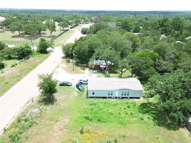 An aerial perspective reveals a private residence nestled amidst verdant surroundings, offering a secluded retreat.