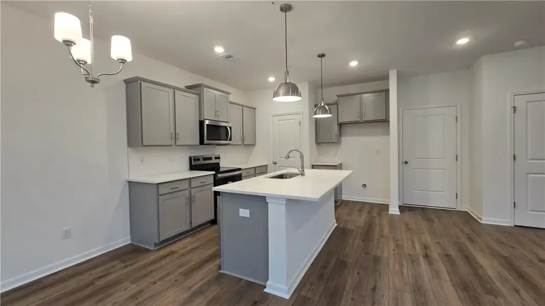 Gleaming stone counters and smooth wood flooring a