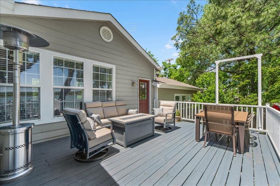 Wooden deck with an outdoor living / dining area