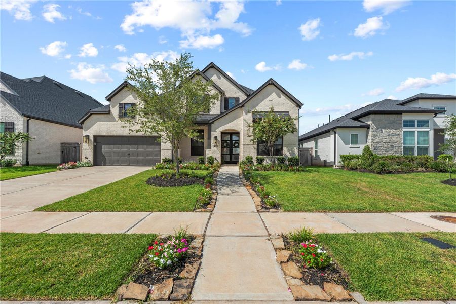 Front exterior of a new home in Sienna, Missouri City, TX, highlighting curb appeal (Image 23).