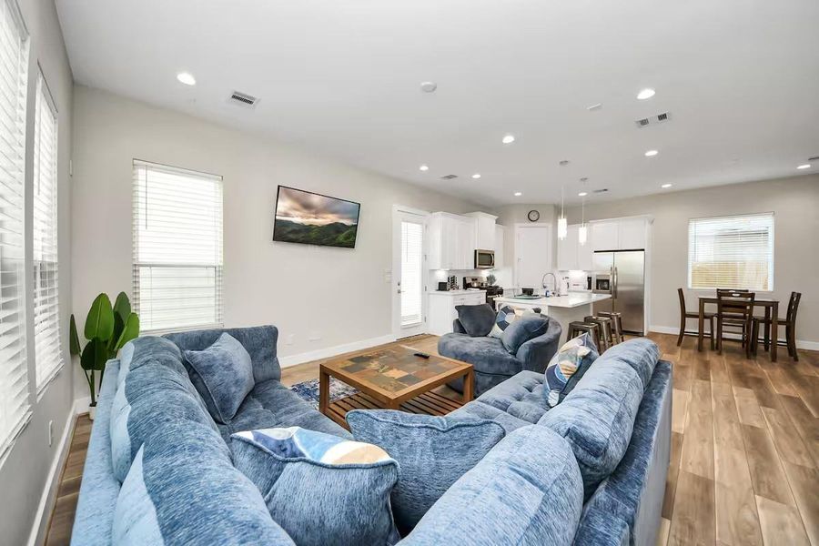 Large windows bring natural light into the heart of the home, while recessed lighting keeps the space bright well into the evening.