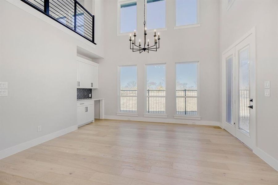Dining area with a wall of windows and modern light fixture
