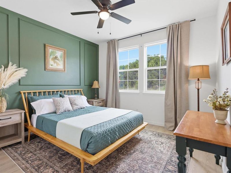 This bedroom has elegant trim work and plenty of natural light from two windows!