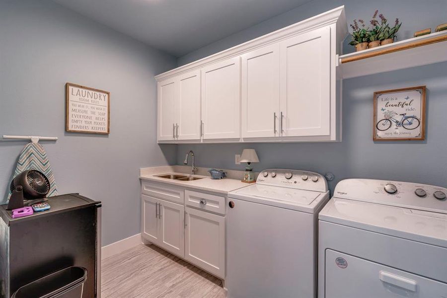 Laundry room with drip/dry area and sink and lots of cabinets
