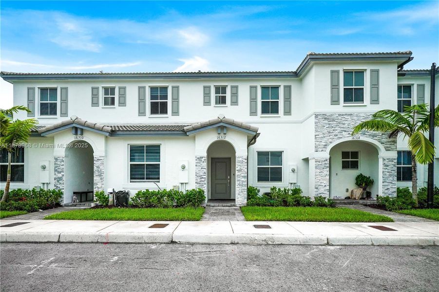 Front exterior of a new home in , Homestead, FL, highlighting curb appeal (Image 20).