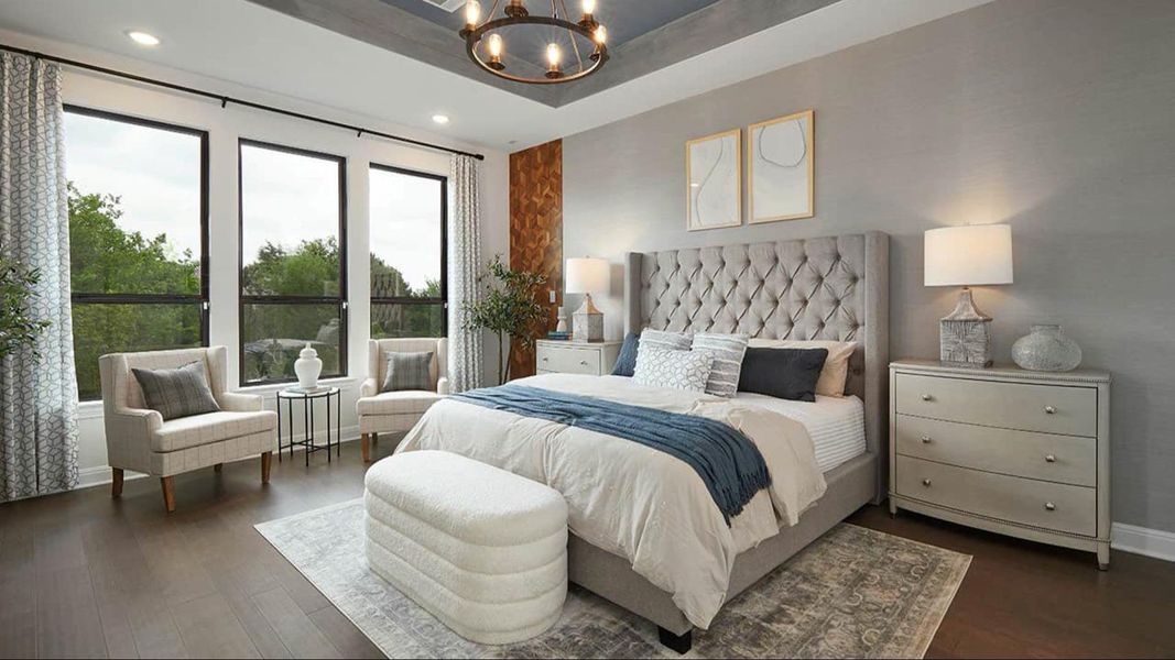 Bedroom featuring a chandelier, a tray ceiling, dark wood-type flooring, and recessed lighting Bedroom featuring a chandelier, a tray ceiling, dark wood-type flooring, and recessed lighting