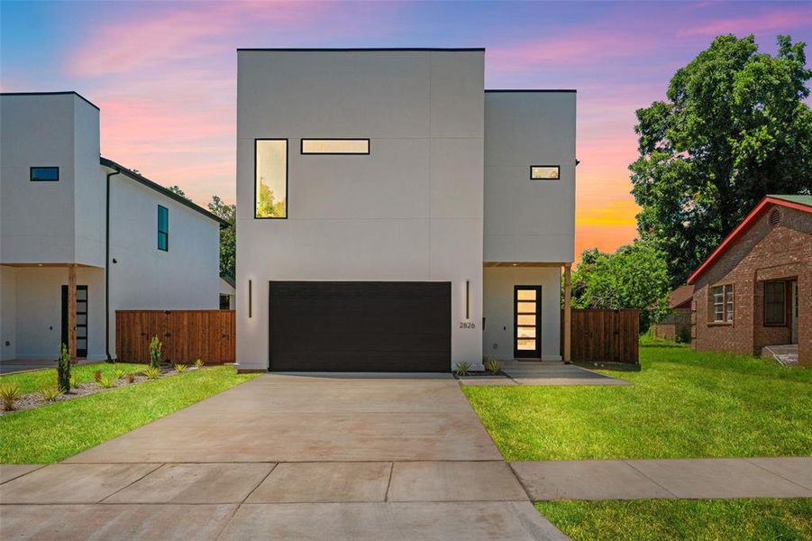 Contemporary house featuring stucco siding, driveway, and a garage Contemporary house featuring stucco siding, driveway, and a garage
