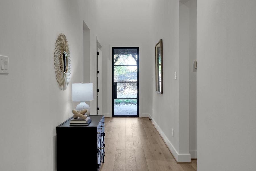 Hallway connecting the front entry to the living and dining areas. Hallway connecting the front entry to the living and dining areas.