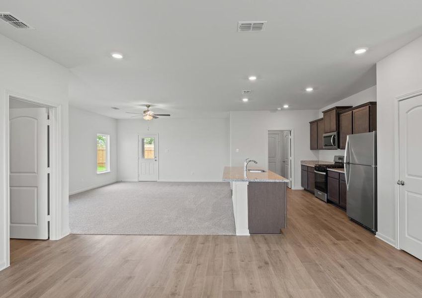 The open-concept layout of this floor plan has the kitchen, family room and dining room sitting next to one another.