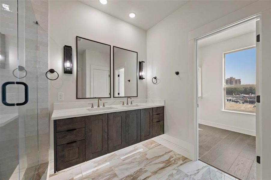 Featuring a beautiful floating vanity and the perfect amount of space for two, this owner's bath is a dream come true!