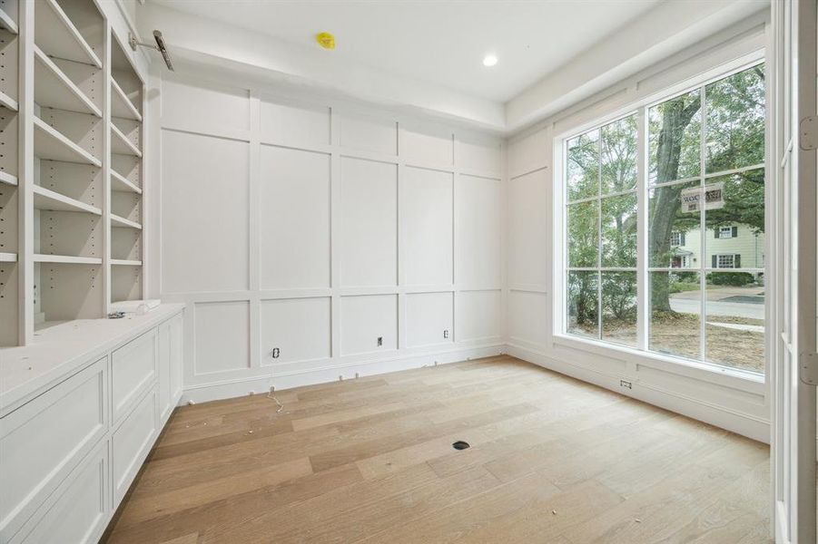 Paneled Study with Built-In Cabinetry and Shelving off the entrance of the home.  Photos as of January 13, 2025.